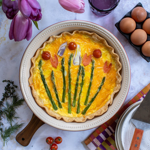 A beautiful spring garden quiche with a fresh veggie design.
